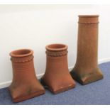 A pair of terracotta chimney pots 45cm high, and a taller example 78cm