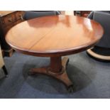 A Victorian mahogany circular table with tilt top and facetted pedestal on triform platform base,