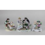 A Sitzendorf porcelain figure group of a couple with a lamb 14cm two other couples of shepherds