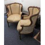 A pair of French style upholstered armchairs with floral carved frames on tapered fluted legs