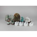 Two Chinese hardstone flower groups 15cm high including base, a porcelain model of a Fo dog on