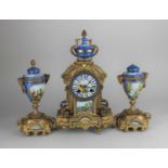 A French gilt metal porcelain mounted mantle clock with garniture, with urn shaped finial above