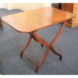 A 19th century mahogany folding campaign table the rectangular top with rounded corners, on x-