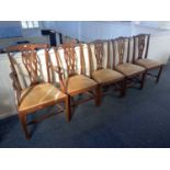 A set of five Chippendale style dining chairs including a carver chair with pierced ribbon splats