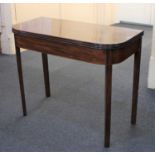 A 19th century mahogany tea table, the rectangular fold-over top with rounded corners and moulded