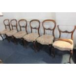 A set of six Victorian balloon back dining chairs with scroll carved back rail, stuff over seats