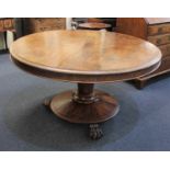 A Victorian circular breakfast table on facetted support and circular base with carved lion paw