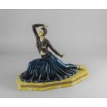 A composite Art Deco style centrepiece of a kneeling figure with one arm raised 30cm high