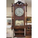 A 19th century parquetry and marquetry inlaid wall clock, with a carved pediment over a glazed