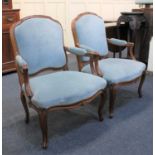 A pair of Louis XV style fauteuil armchairs with blue studded upholstery on cabriole legs