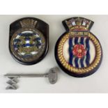 Two Royal Navy ships crests for Morecombe Bay and another mounted on wooden plaques, 26cm and a