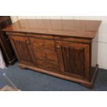 A Victorian style sideboard with three frieze drawers and central drawers flanked by cupboards