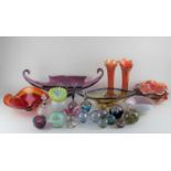 A collection of coloured glass vases and paperweights to include a pair of Carnival glass slender