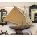 A painted wooden model pond yacht with gaff rig, on wooden stand approx 160cm by 185cm