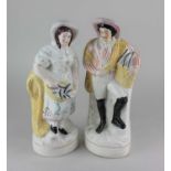 A pair of Staffordshire pottery flatback figures of fisherfolk 34.5cm high