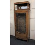 A French display cabinet with raised surmount and mirror above single glazed door enclosing two