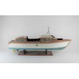 A painted wood pond model motor boat 'Rainbow' with engine (a/f - untested), on stand, boat approx