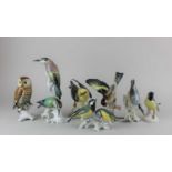 Four Karl Ens porcelain models of birds to include an owl 16cm high and a tree creeper 15cm,