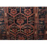 A Persian type rug, red ground, with geometric decoration within multiple borders 200cm by 130cm,