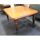 A Victorian mahogany extending dining table with one extra leaf and winder on turned and fluted