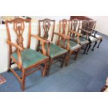 A set of four Chippendale style carver dining chairs with pierced ribbon backs and drop in seats