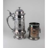 A large silver plated tankard with hinged cover and dolphin cast handle 34cm high, and a plated wine