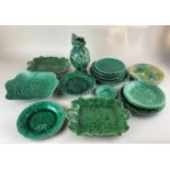 A collection of green majolica leaf patterned plates and dishes, one stamped 'Wedgwood', together