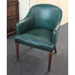 A green leather tub chair on square chamfered legs