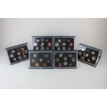 A collection of six Royal Mint UK proof coin collections for1983 (2), 84, 85, 86, 88 with in blue