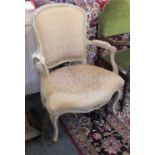 A painted French style open armchair in distressed condition with upholstered back and seat on
