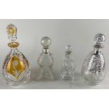 Two silver mounted glass bottles and stoppers, a Bohemian cut glass decanter faceted in amber, and