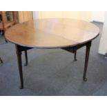 A George III oak drop leaf dining table with oval top on tapered legs to pad feet 116cm