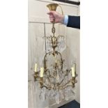 A set of four brass nine-branch chandeliers with glass drops (a/f)