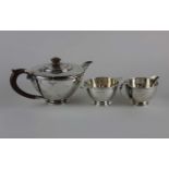 A George VI Art Deco silver three piece tea set circular form consisting of teapot, cream jug and