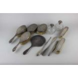 A George V silver six piece dressing table set to include handmirror, two pairs of brushes and a