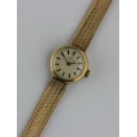 An Omega 9ct gold circular cased lady's bracelet wristwatch, the signed silvered dial with baton