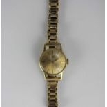 A Tissot gold circular cased lady's wristwatch with a signed jewelled movement, detailed within