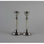 A pair of moden silver candlesticks baluster form on circular loaded bases, maker A T Cannon,