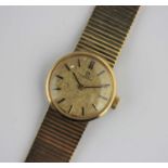 An Omega 9ct gold ladies bracelet wristwatch the signed gilt dial with baton hour markers on a
