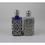 A pair of white metal mounted blue and clear glass scent bottles (missing stoppers), 12cm high