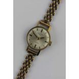 A Rotary gilt metal fronted and steel backed ladies wristwatch fitted to a 9ct gold bracelet