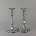 A pair of silver plated candlesticks baluster shape cast with scrolling foliage, removable drip