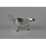 A modern silver sauce boat with scroll handle on three lions paw feet, maker Francis Howard,