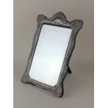A modern silver framed dressing table mirror with a scrolled embossed border (a/f) Sheffield 1991,
