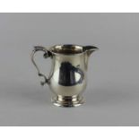 A George V silver cream jug baluster form with foilate cast scroll handle, maker Barker Brothers,