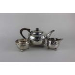 A George V Arts & Crafts silver hammered three piece tea set, maker Albert Edward Jones,