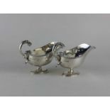 A pair of George III style silver sauce boats with gadrooned border, flying scroll handles on oval