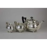 A George VI silver three-piece tea service rounded rectangular form with gadrooned rim on ball feet,