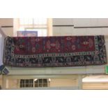 A Persian type rug, red ground, with geometric motifs within a multiguard border, approx 277cm by