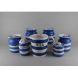 Four TG Green & Co Cornish Kitchen ware blue and white striped storage jars and a flour shaker (